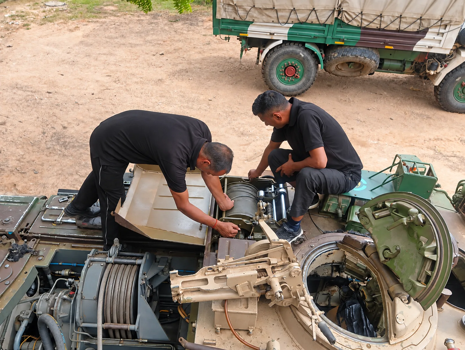 Technicians servicing a recovery vehicle winch